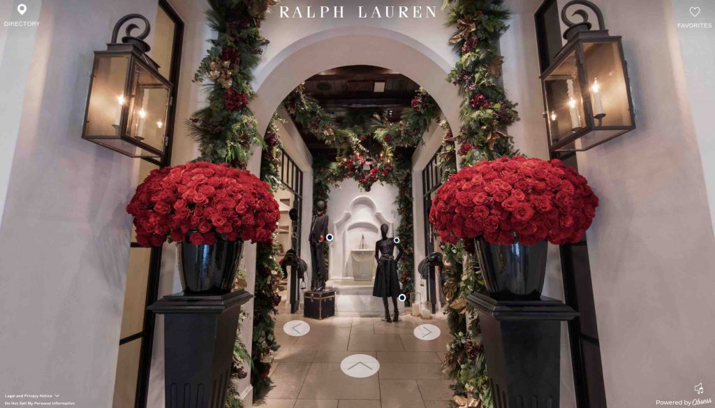 arched entryway to the Ralph Lauren Virtual experience with large floral bouquets and garland decorating the entrance